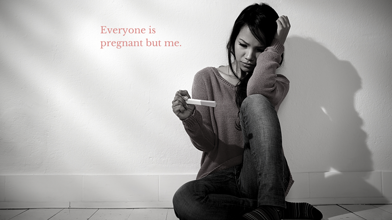 Photograph of Woman Sitting on the Ground Looking At a Pregnancy Test