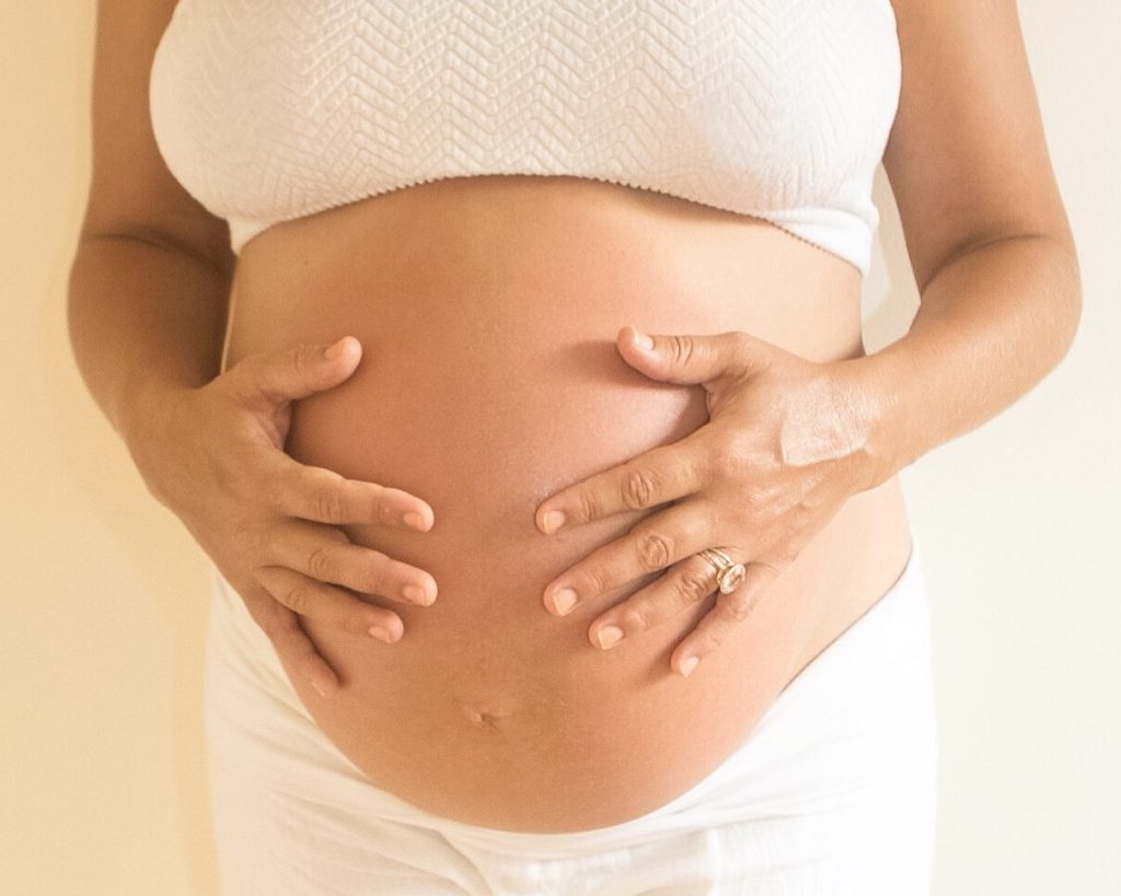 Image of Pregnant Female Holding her Stomach