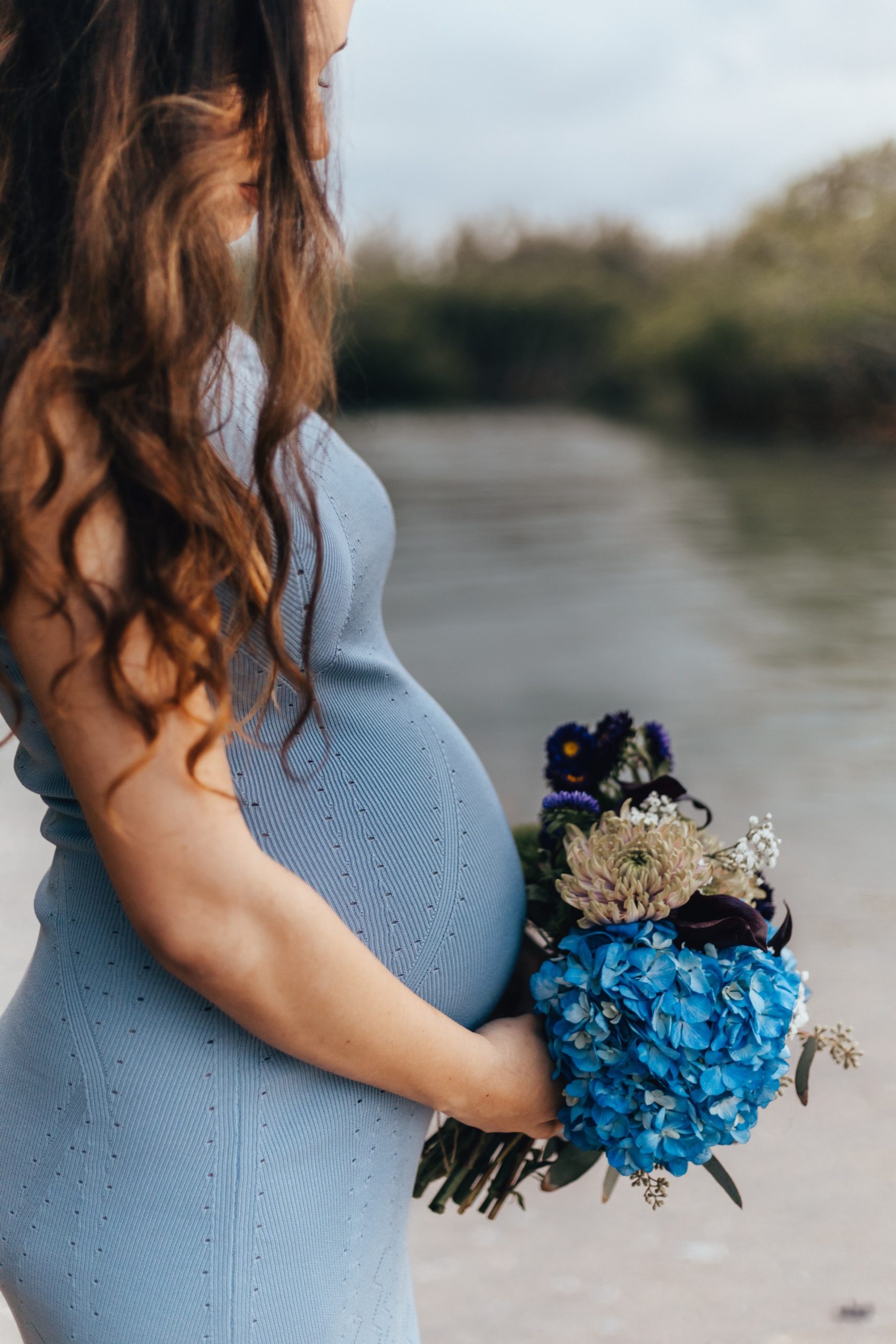 pregnant woman holding flowers