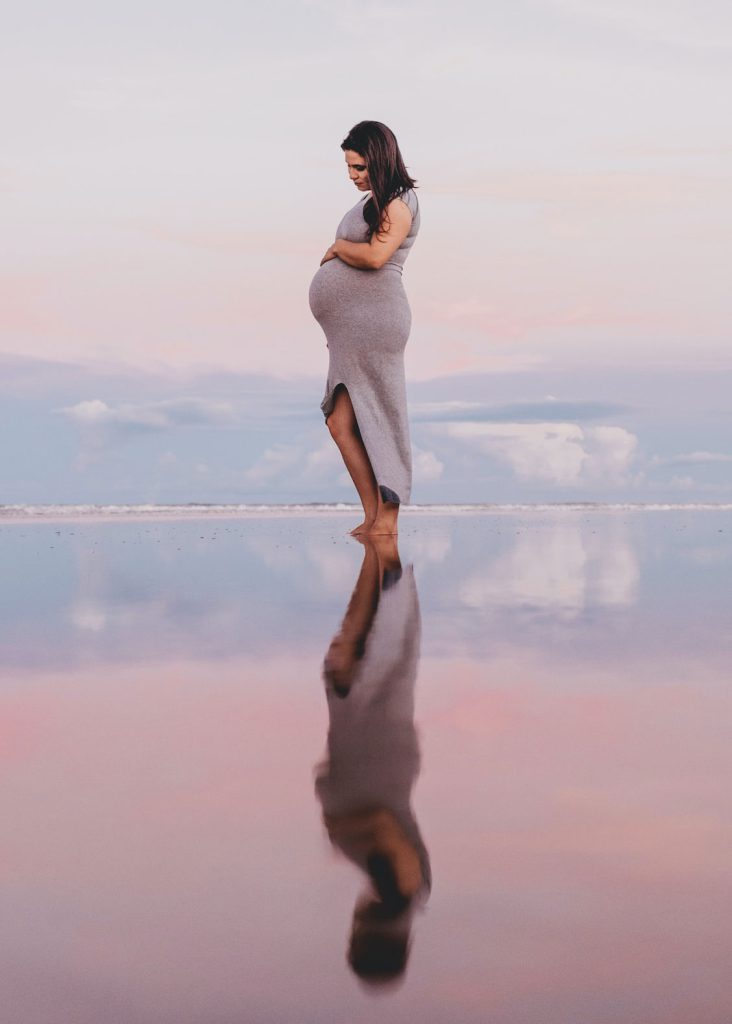 Pregnant woman standing in the sea